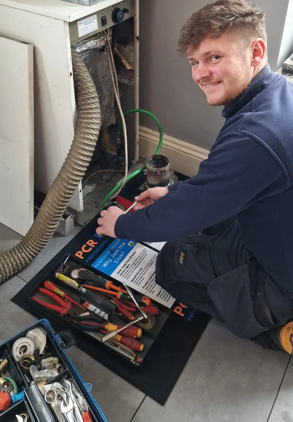 Alex from PCR Plumbers servicing a 30-year-old oil boiler in Cawood