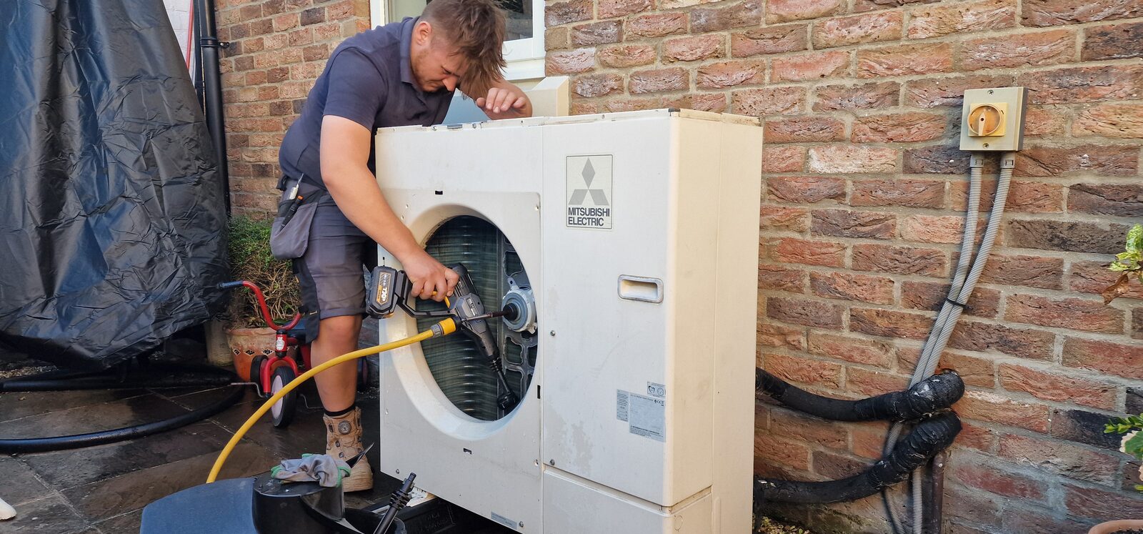 Alex from PCR carrying out a full strip-down service on a Mitsubishi Ecodan air-source heat pump in Stillingfleet